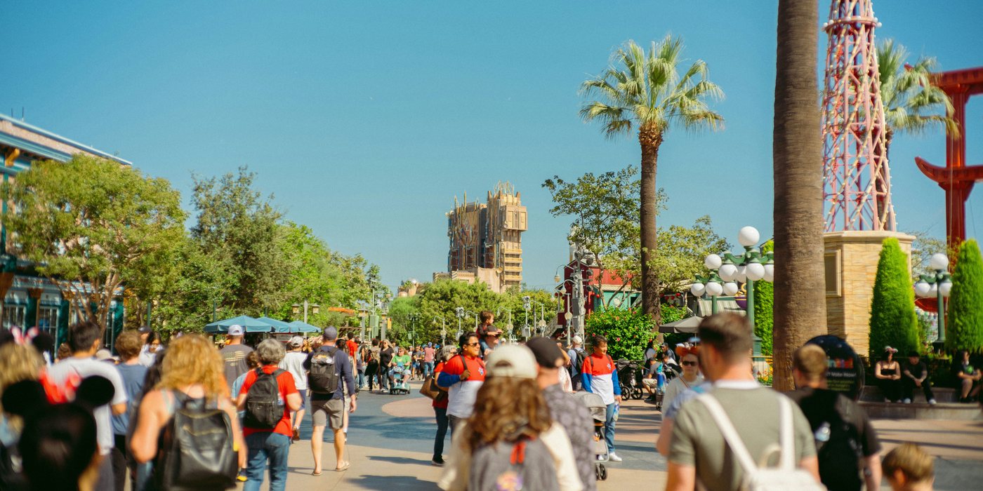 crowds walking through a theme park midway